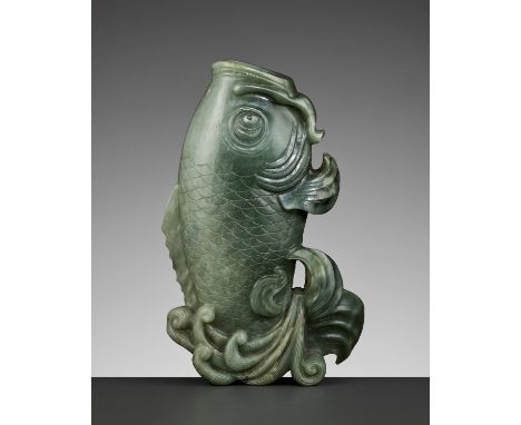 A GREEN JADE 'CARP' VASE, QING DYNASTYChina, 18th - 19th century. Vividly carved as a carp leaping from crashing waves, depic