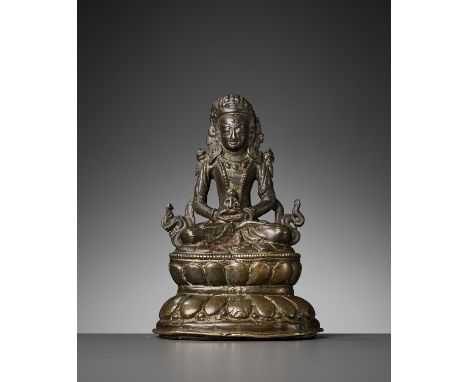 A NEPALESE BRONZE FIGURE OF AMITAYUS, MEDIEVAL PERIODC. 11th-14th century. Seated in dhyanasana atop a waisted double-lotus b