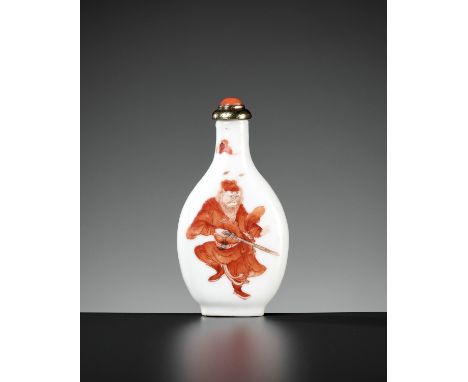 AN IRON RED PORCELAIN 'ZHONG KUI' SNUFF BOTTLE, 19TH CENTURYChina. Of pear shape, rising from an oval foot ring to a long tub