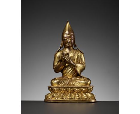 A GILT-COPPER REPOUSSE FIGURE OF A LAMA, 18TH CENTURYTibetan-Chinese. Seated in dhyanasana on a double lotus base with beaded