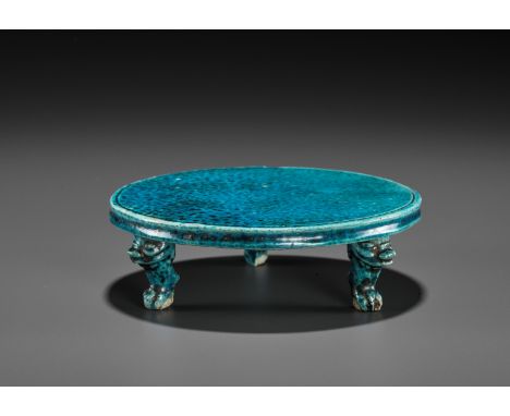 A TURQUOISE-GLAZED TRIPOD STAND, KANGXI PERIODChina, second half of 17th to early 18th century. The flat circular top is supp