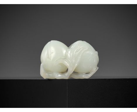 A WHITE JADE 'DOUBLE PEACH' CARVING, QING DYNASTYChina, 18th to early 19th century. Deftly carved as two peaches issuing from