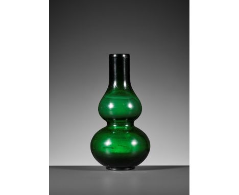 A TRANSLUCENT GREEN DOUBLE-GOURD GLASS VASE, GUANGXU MARK AND PERIODChina, 1875-1908. Thickly molded from a solid block of bu