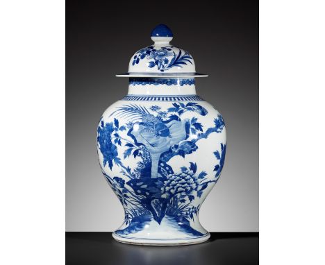 A BLUE AND WHITE BALUSTER JAR AND COVER, QING DYNASTYChina, 19th century. Painted around the curving walls depicting a contin