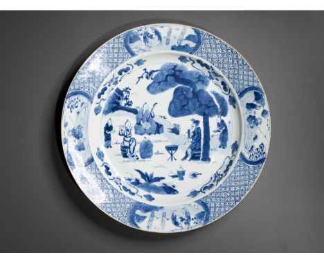 A BLUE AND WHITE 'MUSICIANS' DISH, KANGXI PERIODChina, 1662-1722. The shallow rounded sides rising from a short tapered foot 