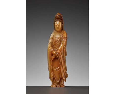 A CARVED SOAPSTONE FIGURE OF GUANYIN, LATE QING TO REPUBLICChina, 1850-1949. Finely carved standing with her hands clasped at