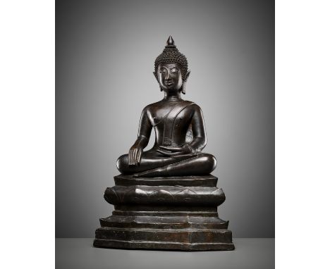 A BRONZE FIGURE OF BUDDHA SHAKYAMUNI, 16TH-17TH CENTURYLaos. Seated in virasana atop a shaped tiered base with incised lotus 