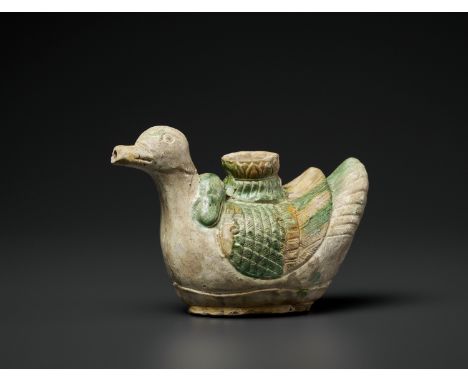 A SANCAI-GLAZED 'DUCK' CERAMIC EWER, LIAO DYNASTYChina, 916-1125. The ewer is sturdily potted, yet subtly modeled into the sh