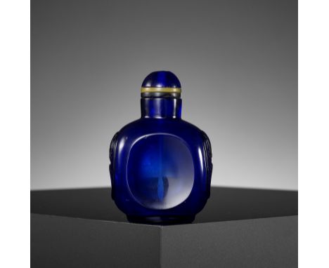 A SAPPHIRE-BLUE GLASS 'INTEGRAL DISH' SNUFF BOTTLE, 18TH CENTURYChina. The transparent bottle of rectangular form, with mask 