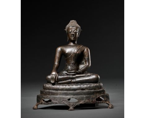 A BRONZE FIGURE OF BUDDHA SHAKYAMUNI, LAN NA KINGDOMNorthern Thailand, 17th century. Seated in virasana atop a tiered and ope