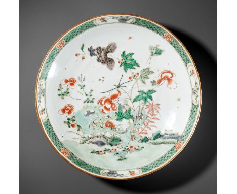 A FAMILLE VERTE 'FLOWERS AND BUTTERFLY' DISH, KANGXI PERIODChina, 1661-1722. Sturdily potted, the interior vividly enameled w
