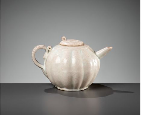 A RARE LOBED QINGBAI EWER AND COVER, SONG DYNASTYChina, 960-1279. The globular body supported on a short foot and surmounted 