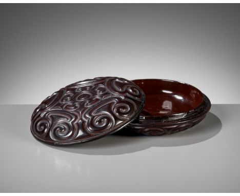 A BLACK TIXI LACQUER CIRCULAR BOX AND COVER, MING DYNASTYChina, 15th-16th century. The domed circular cover with a stylized c