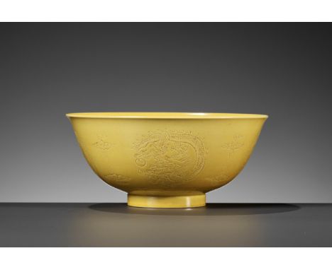 A YELLOW-GLAZED INCISED 'DRAGON' BOWL, GUANGXU MARK AND PERIODChina, 1875-1908. Well potted with deep rounded sides rising fr
