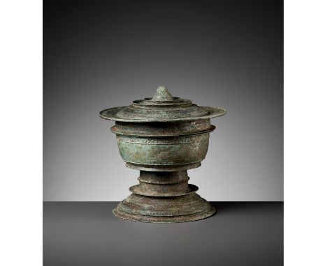 A KHMER BRONZE FOOTED BOWL AND COVER, ANGKOR PERIODCambodia, 12th-13th century. The bowl supported on a stepped spreading foo
