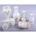 A Belleek vase with pierced rim, 7 3/4" high, a Belleek pot and cover, four other pieces of
