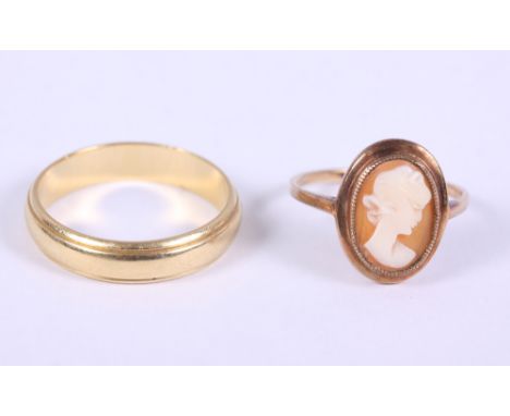 An 18ct gold wedding band, 5.7g, and a yellow metal cameo ring, stamped 9ct, 2.1g