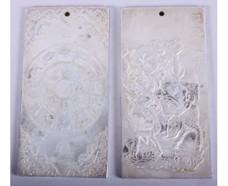 Two Chinese white metal scroll weights with embossed decoration, 4" high