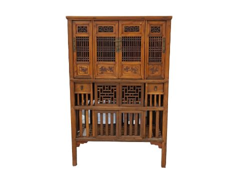 LARGE CHINESE TEAK PIERCED STORAGE CUPBOARDwith a moulded top, above a central pair of cupboard doors flanked by single doors