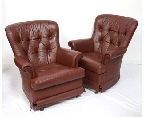 PAIR OF LEATHER ROCKING ARM CHAIRSwith button back detail and scroll arms above a shaped seat, with wheels and both in brown 
