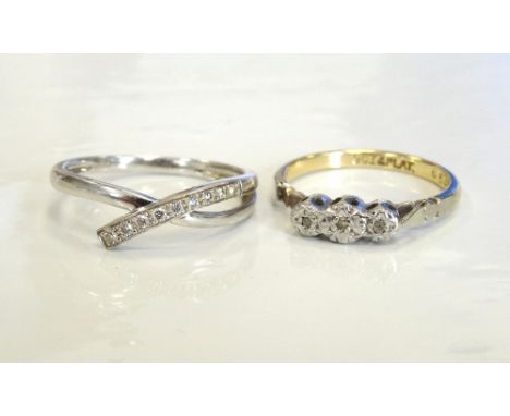 TWO DIAMOND RINGSone with nine diamonds in twist setting, on nine carat white gold shank, the other an illusion set three sto