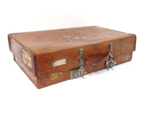 VINTAGE 'REVELATION' LEATHER BOUND SUITCASEwith interior straps, the outer case bears various travel labels, with key