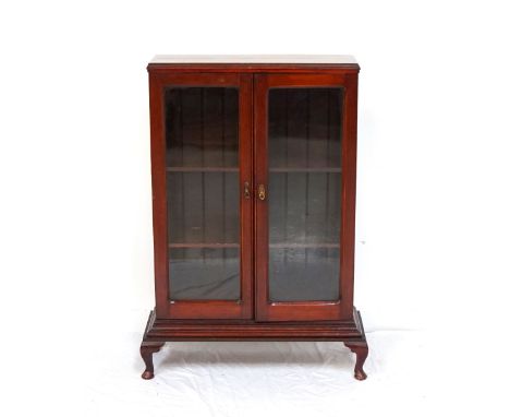 VINTAGE STAINED PINE BOOKCASEwith double glazed doors, raised on short cabriole legs, 115cm high x 82.5cm wide