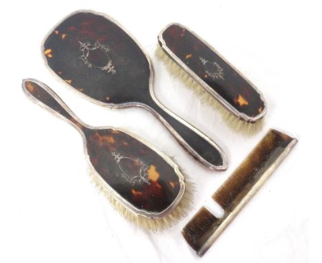 EDWARDIAN SILVER AND TORTOISE SHELL DRESSING TABLE SETcomprising a hand mirror, two brushes and a comb, Birmingham 1902 (4) 