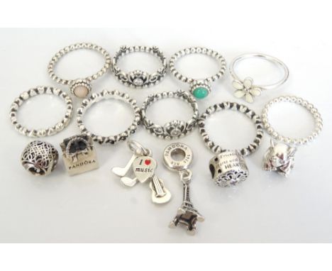 SELECTION OF NINE PANDORA SILVER RINGSincluding gem set examples; and six loose silver Pandora charms including the Eiffel To