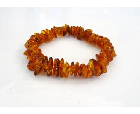 'COPPERSON' AMBER BEAD BRACELETformed with irregular amber beads on elasticated band, with Copperson Amber leaflet