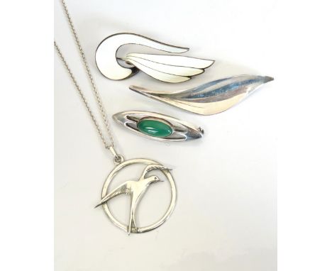 FOUR PIECES OF DESIGNER SILVER JEWELLERYcomprising a Norwegian white enamel decorated silver brooch by Aksel Holmsen; a Danis
