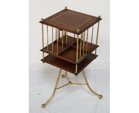MAHOGANY REVOLVING BOOKCASEthe top with leather skiver, the body with brass rails and mounts, with undertier, raised on shape