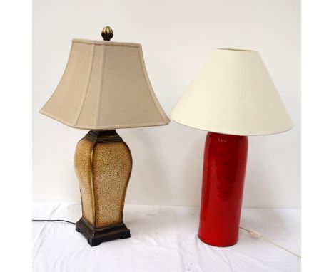 DECORATIVE SHAPED TABLE LAMPwith a cream crackle glazed body and a shaped taupe shade, 82cm high, and a red pottery table lam