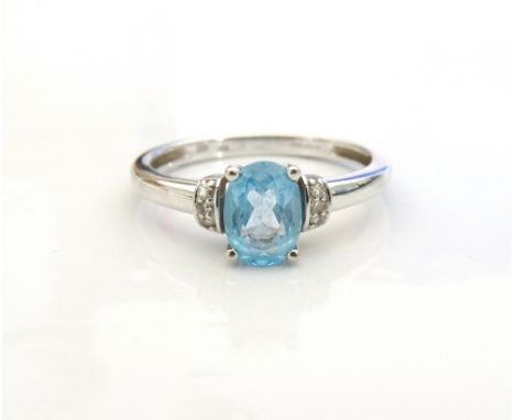 AQUAMARINE AND DIAMOND RINGthe central oval cut aquamarine flanked by three diamonds to each shoulder, on nine carat white go