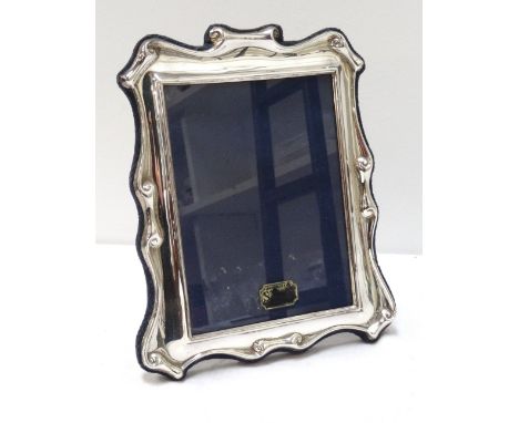 SILVER PHOTOGRAPH FRAMEby R Carr Ltd, the shaped rectangular frame with scroll detail, on easel support, 18.5cm x 14cm