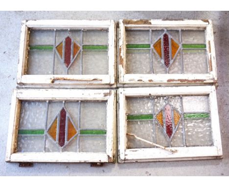 SET OF FOUR STAINED GLASS WINDOWSearly 20th century, each panel with a central red and yellow diamond shape flanked by green 