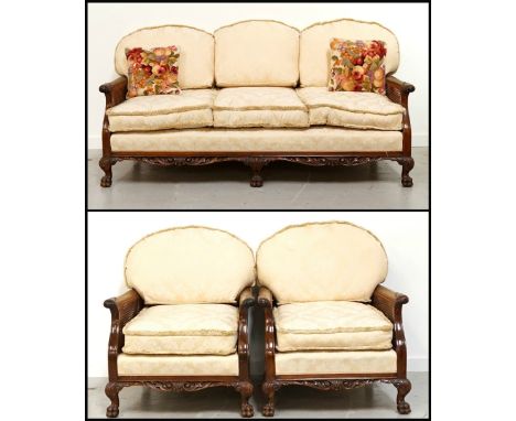 WALNUT BERGERE THREE PIECE SUITEcomprising a large sofa, 188.5cm wide, and two armchairs, the shaped carved backs with centra