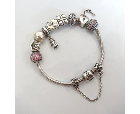 PANDORA MOMENTS SILVER CHARM BRACELETwith nine various charms and a safety chain, the charms including a dog kennel, a presen