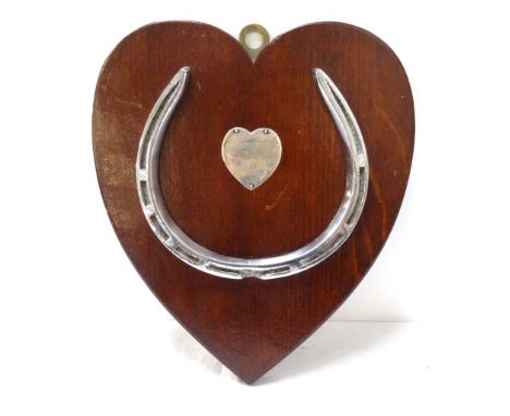 PRESENTATION HORSESHOE PLAQUEthe horseshoe on heart shaped wooden mount with unmarked silver plaque engraved 'Ousethorp 1933-