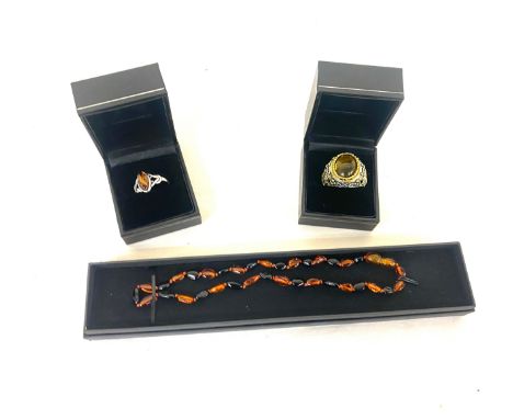 Selection of amber jewellery includes Necklace, Silver and amber ring and a insect insert ring 