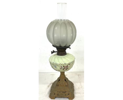 Victorian oil lamp on cast base measures 25 inches tall 