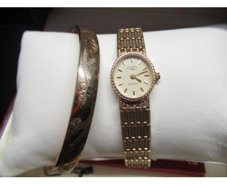 Rotary quartz Ladies cocktail watch in a 9ct gold case stamped 375 with booklet and a 9ct rolled gold bright cut hinged bangl