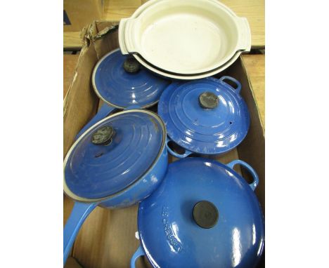 Two Le Creuset blue enamel cast iron lidded casserole pans, two matching sauce pans, two matching serving dishes 