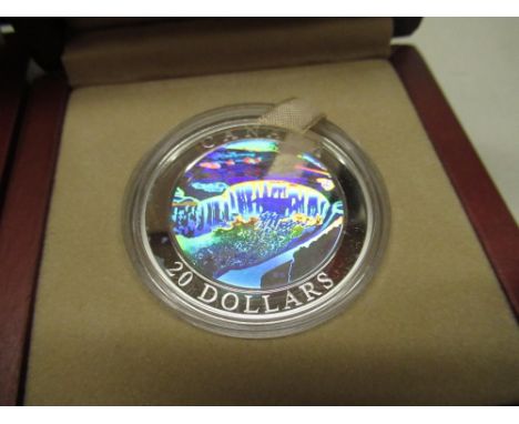 Three Royal Canadian Mint 20 dollar silver proof coins, featuring the Rockies, Northern Lights, Niagara Falls, boxed in woode