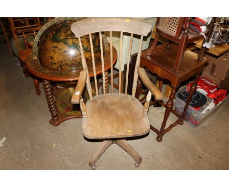 An elm seated stick back swivel chair