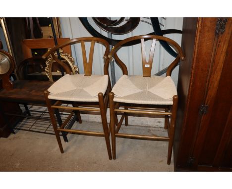 A pair of Ercol style tub shaped high seat stools with string seats