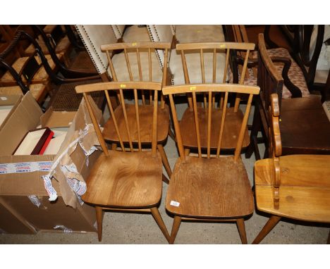 A set of four blonde Ercol stick back dining chairs