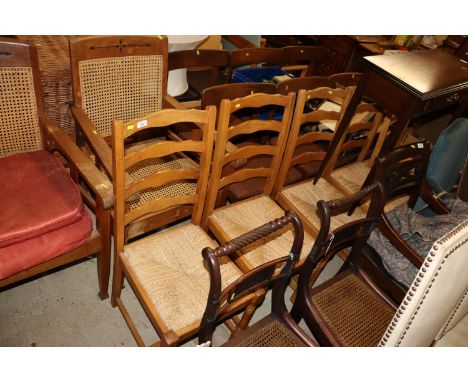 A set of four ladder back rush seated dining chairs and another similar