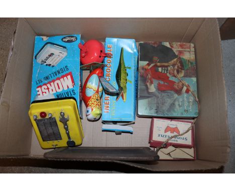 A box of various vintage tin and other toys