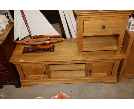 A light wood unit fitted shelf and cupboards